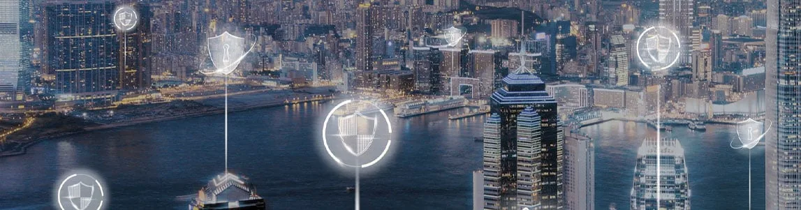 This image shows a city skyline at night with illuminated buildings along a river, overlaid with digital icons representing cybersecurity concepts such as shields, locks, and data protection. The overlay suggests themes of smart city infrastructure and digital security integration.
