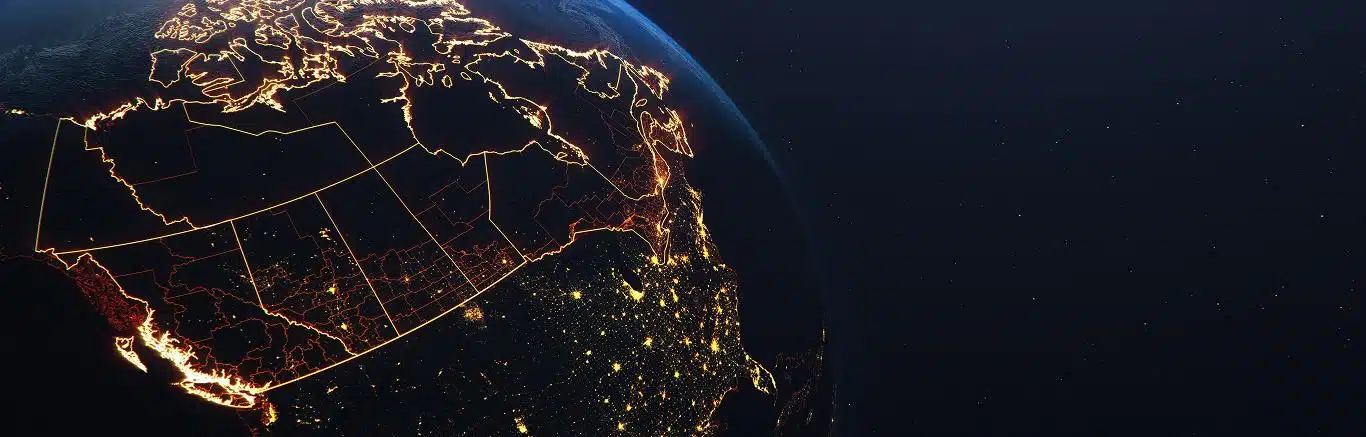 This image shows a glowing satellite view of Canada and the northern United States at night, with provincial and state borders illuminated in bright lines. Densely lit areas highlight major urban centers, particularly in the eastern U.S. and southern Canada, while the western and northern regions appear darker and more sparsely populated.